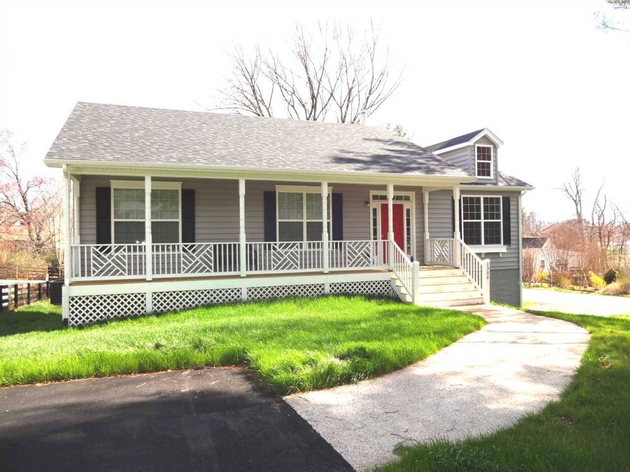 1214 Swift Run Road Ruckersville, VA 22968 - Photo 3 of 4 a front view of a house with a garden and yard