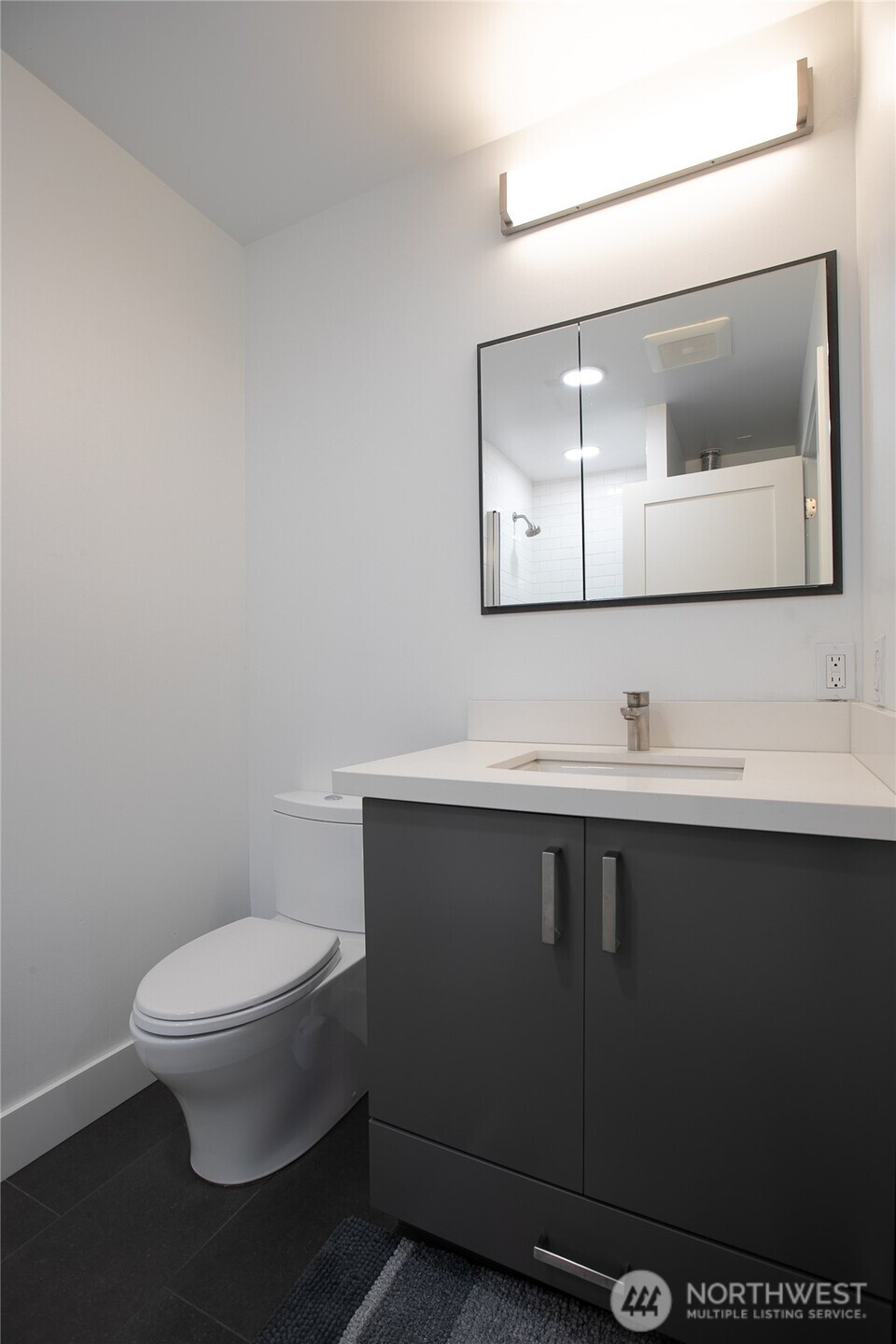4727 36th Avenue Southwest Seattle, WA 98126 - Photo 4 of 29 a bathroom with a sink mirror and toilet