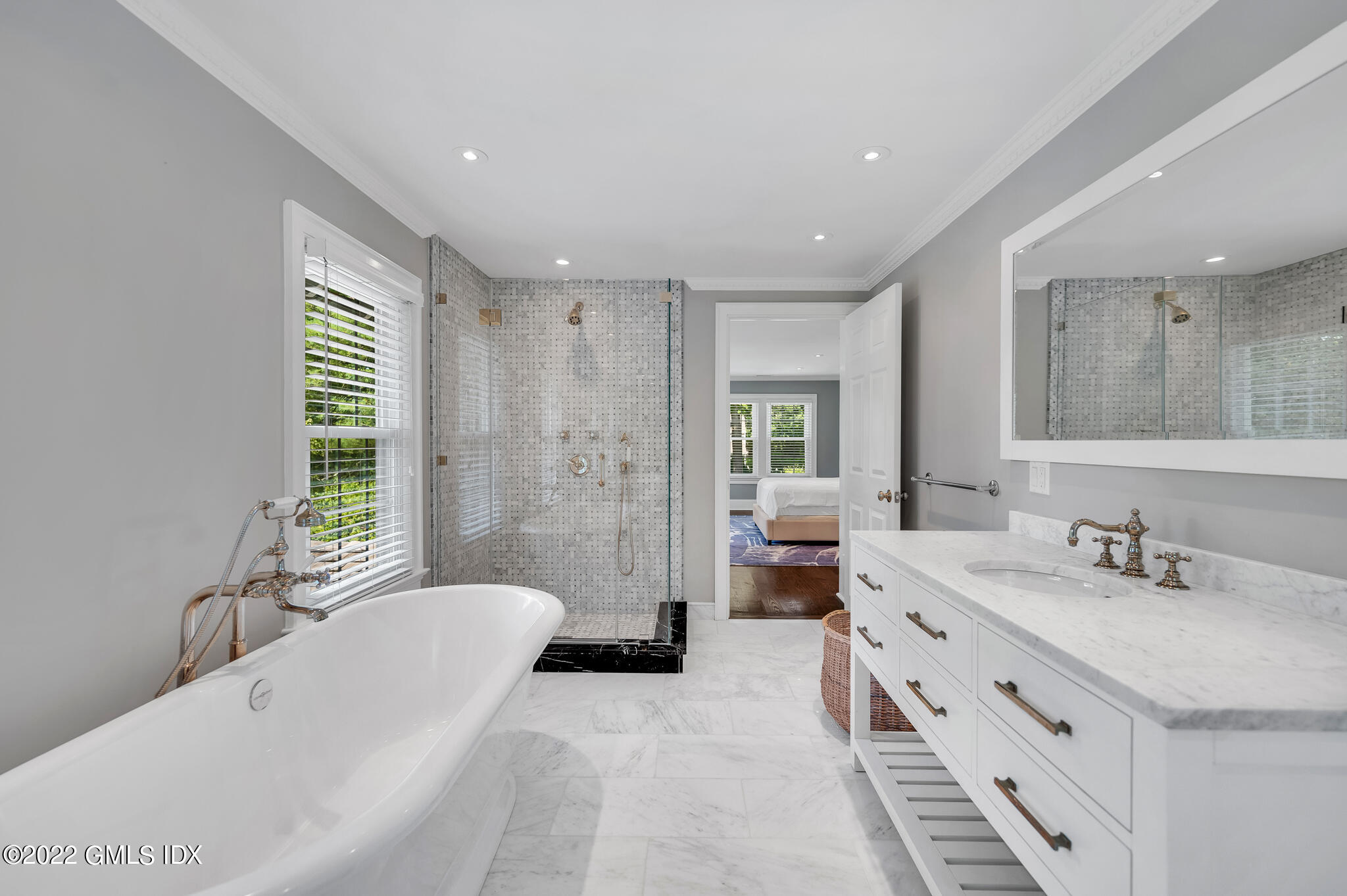 269 Stanwich Road Greenwich, CT 06830 - Photo 13 of 19 a bathroom with a tub a double vanity sink a mirror and a bathtub
