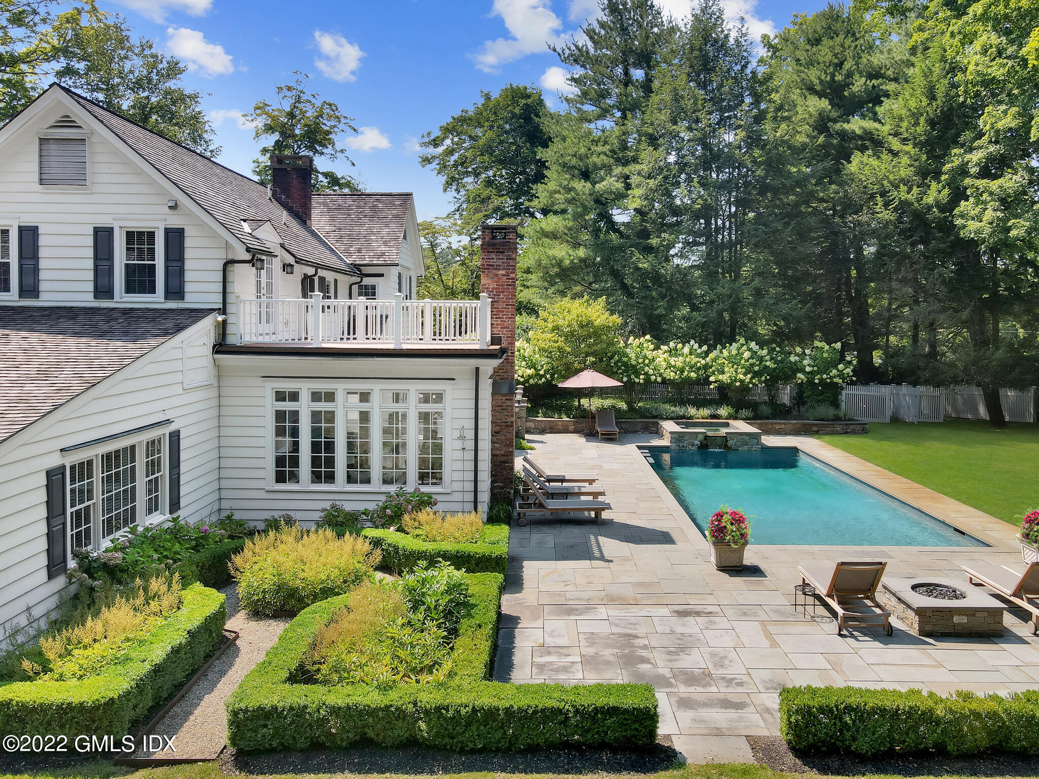 269 Stanwich Road Greenwich, CT 06830 - Photo 3 of 19 a view of a house with a yard and plants