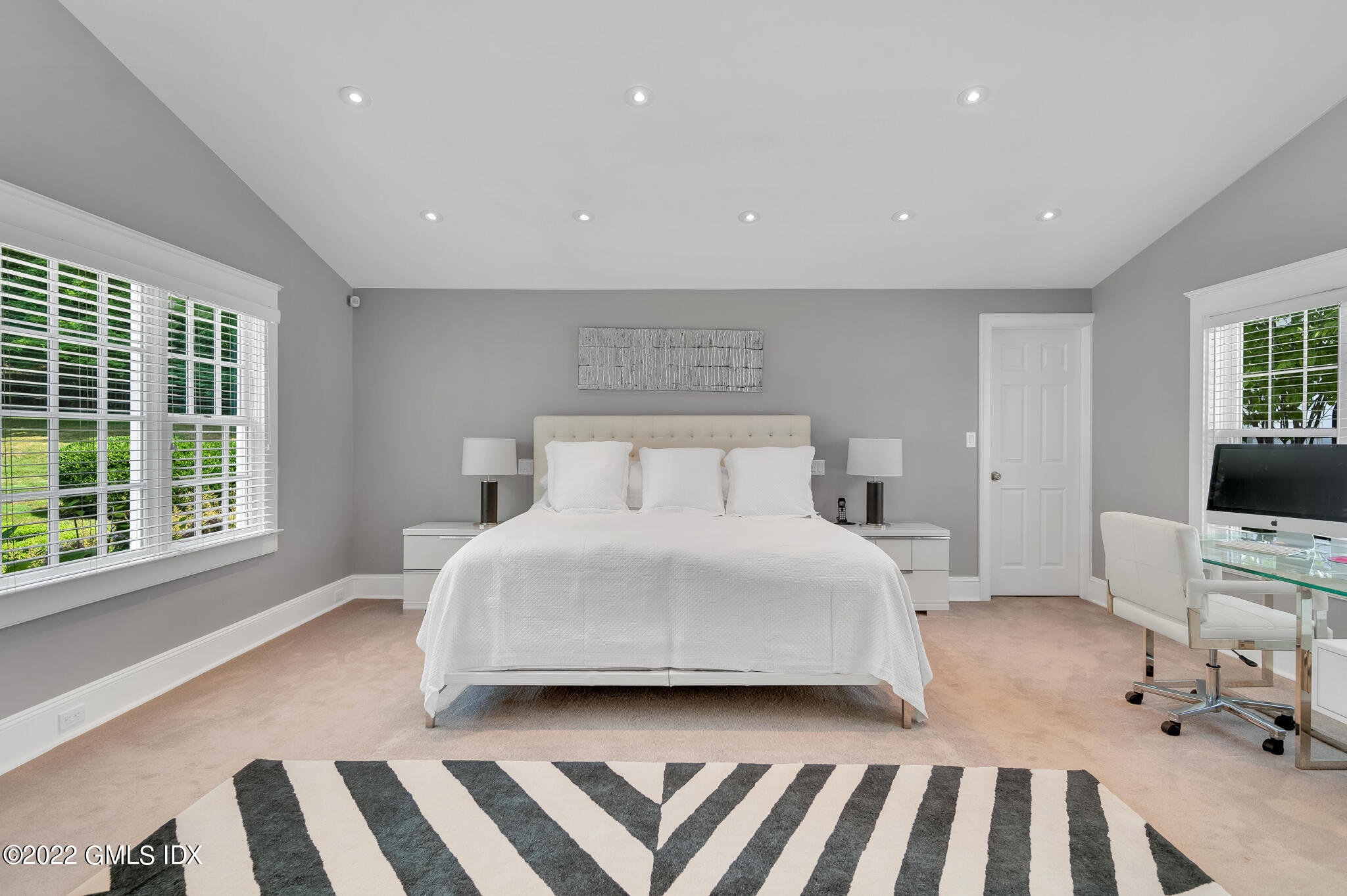 269 Stanwich Road Greenwich, CT 06830 - Photo 9 of 19 a bedroom with a bed and a large window