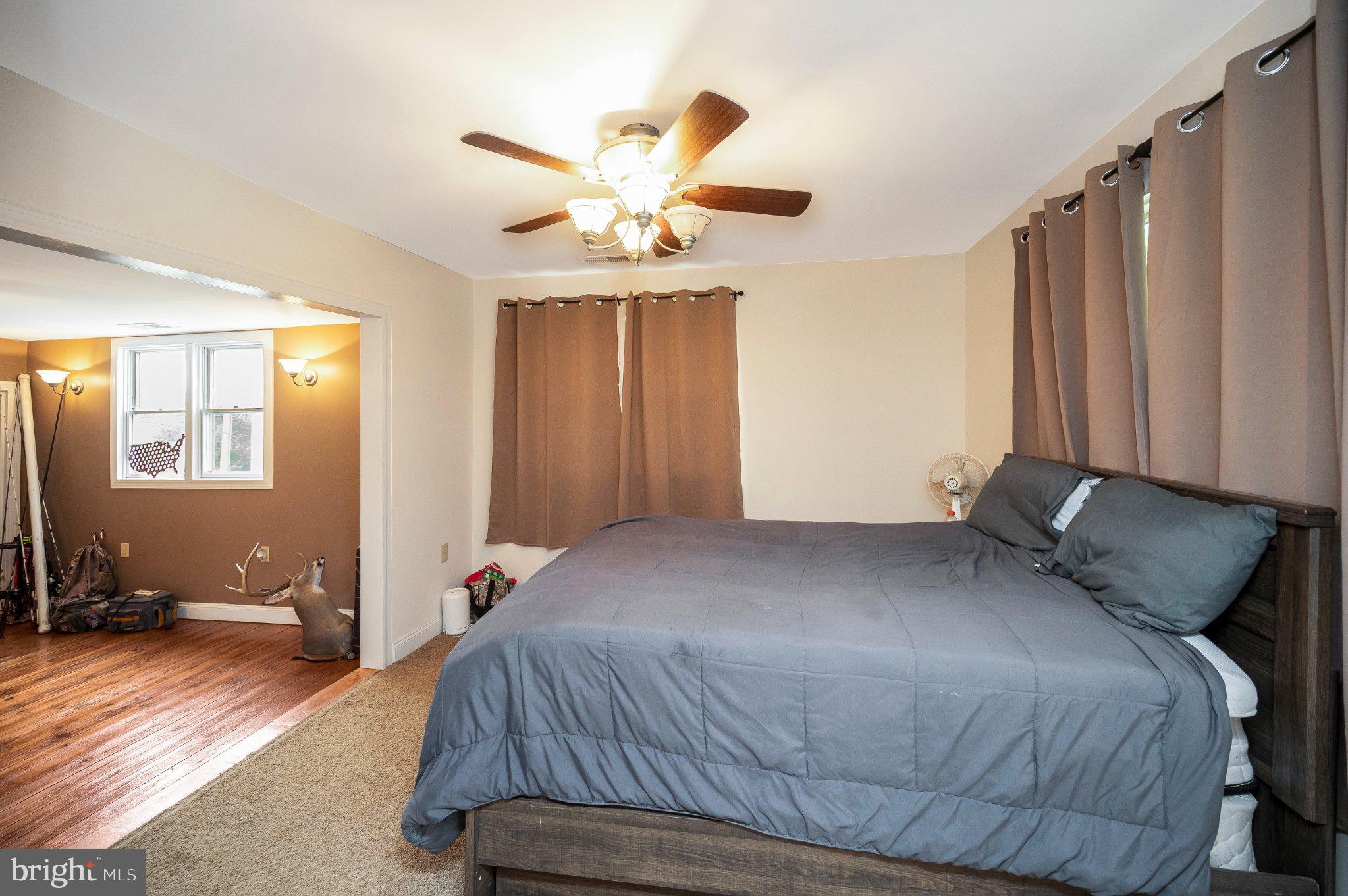 23202 Village Road Unionville, VA 22567 - Photo 33 of 58 a bedroom with a bed and wooden floor
