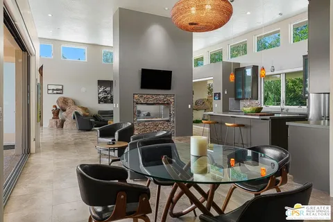 a kitchen with stainless steel appliances granite countertop a stove a sink a refrigerator and a microwave