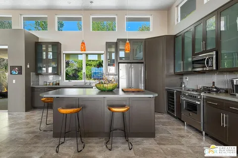 a kitchen with stainless steel appliances granite countertop a sink and a stove