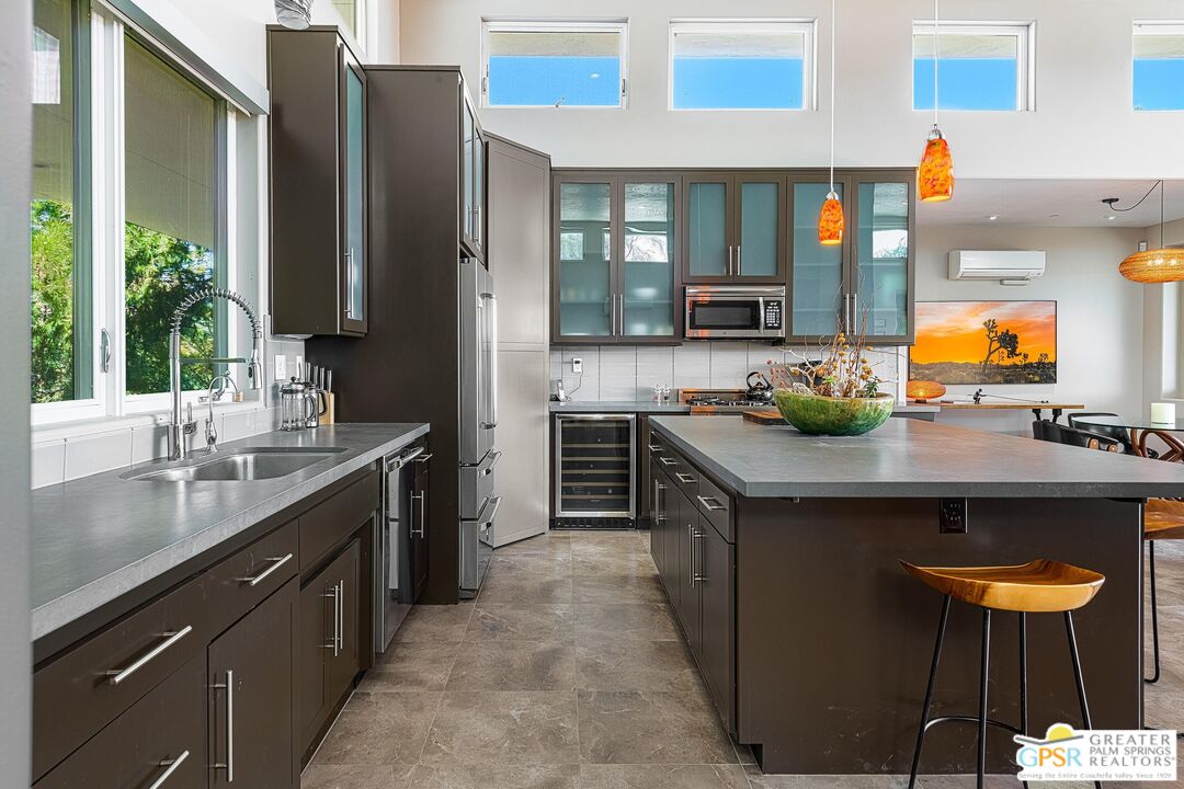 4974 Avenida Del Sol Joshua Tree, CA 92252 - Photo 19 of 36 a kitchen with stainless steel appliances granite countertop a sink and a stove