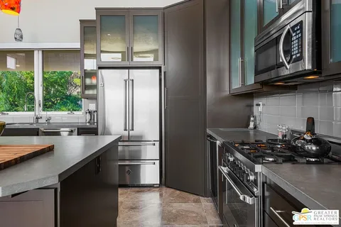 a kitchen with stainless steel appliances granite countertop a stove and a microwave