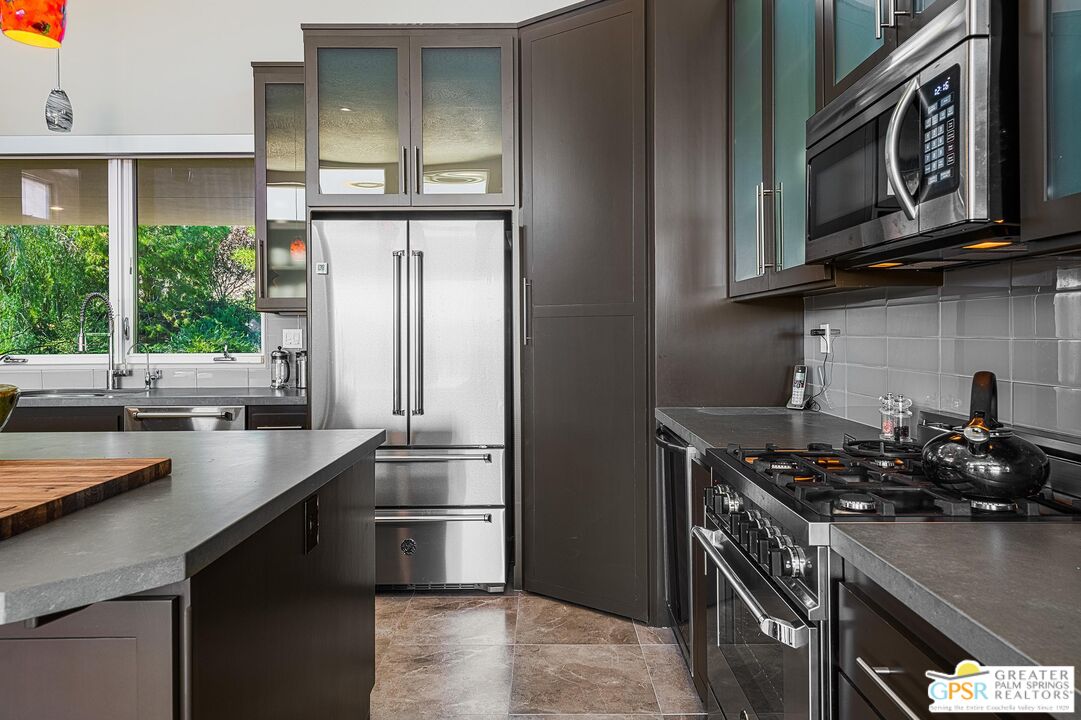 4974 Avenida Del Sol Joshua Tree, CA 92252 - Photo 20 of 36 a kitchen with stainless steel appliances a sink stove and refrigerator