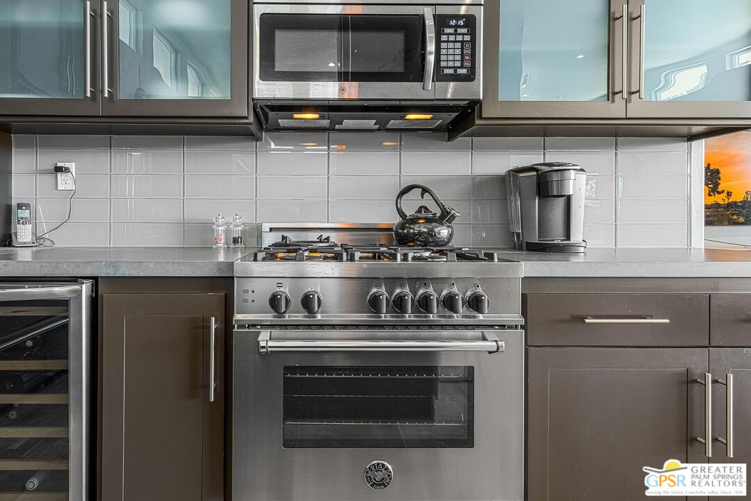 4974 Avenida Del Sol Joshua Tree, CA 92252 - Photo 21 of 36 a kitchen with stainless steel appliances granite countertop a stove and a microwave