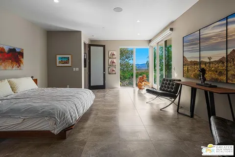 a living room with furniture and a floor to ceiling window