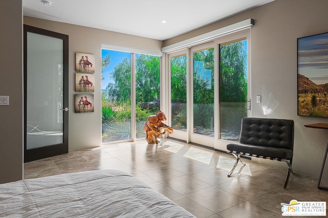 4974 Avenida Del Sol Joshua Tree, CA 92252 - Photo 23 of 36 a living room with furniture and a floor to ceiling window