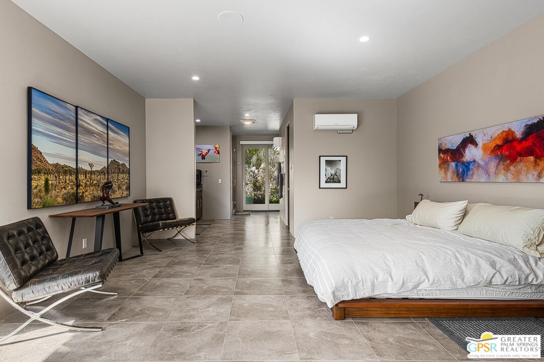 4974 Avenida Del Sol Joshua Tree, CA 92252 - Photo 24 of 36 a bedroom with a bed and wooden floor