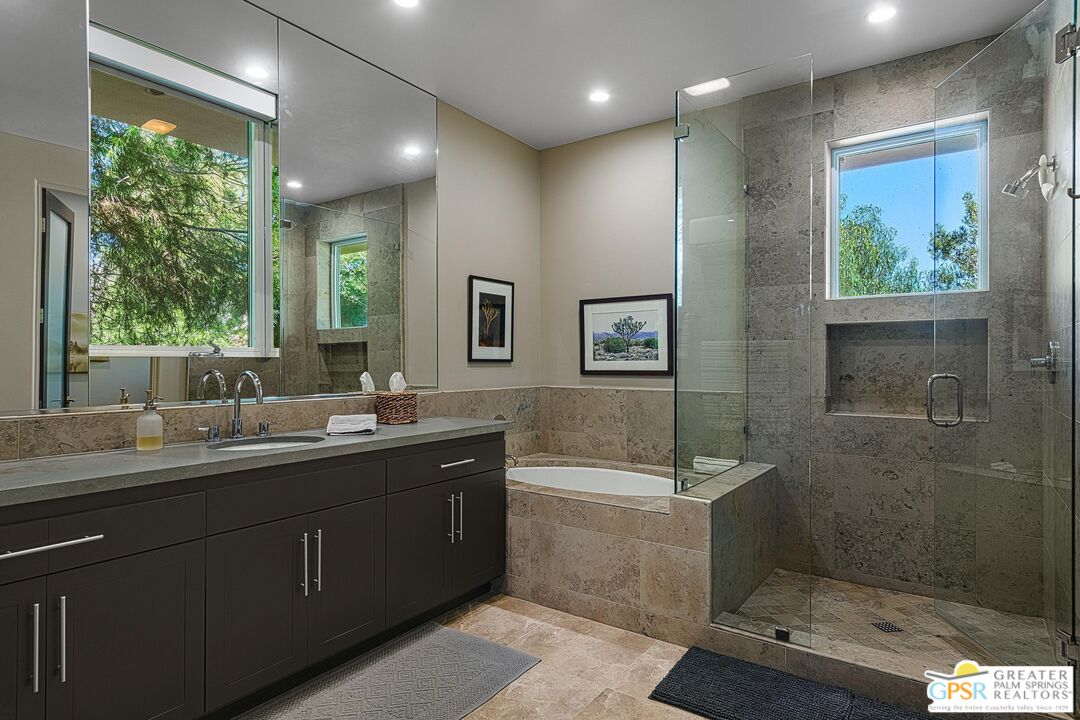 4974 Avenida Del Sol Joshua Tree, CA 92252 - Photo 29 of 36 a bathroom with a double vanity sink toilet and shower