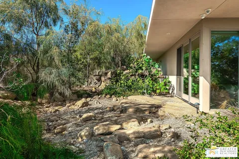a view of a swimming pool with a yard and seating area