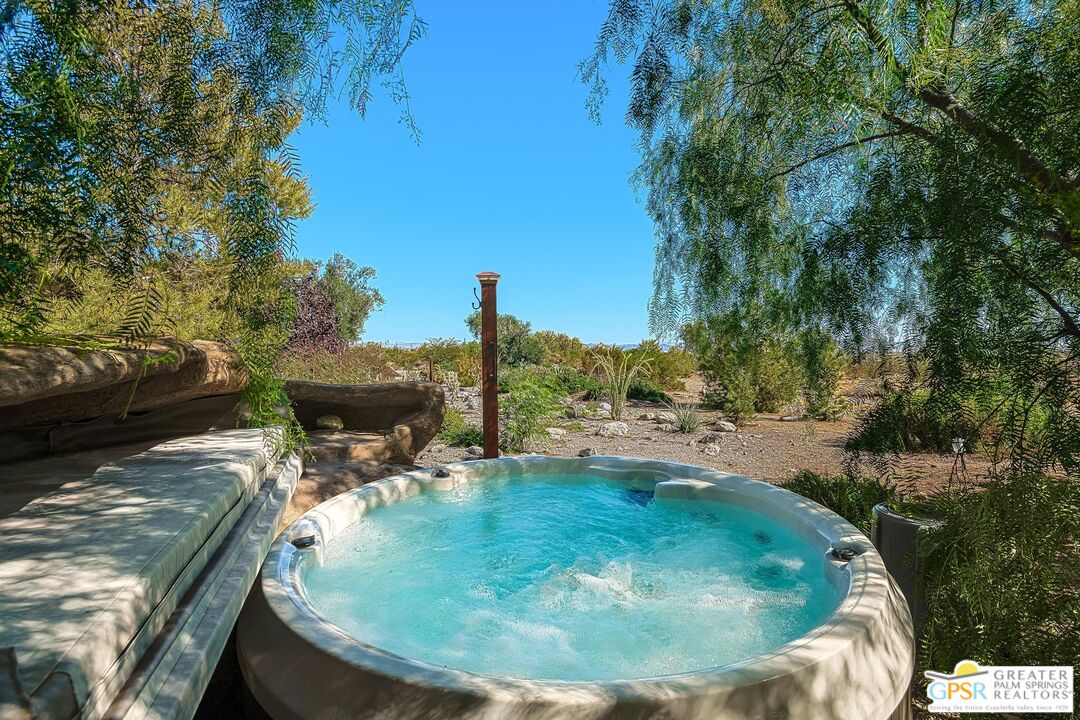 4974 Avenida Del Sol Joshua Tree, CA 92252 - Photo 31 of 36 a view of a swimming pool with a yard and seating area