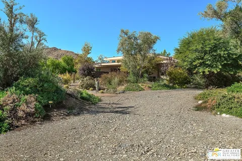 a view of a garden with a house