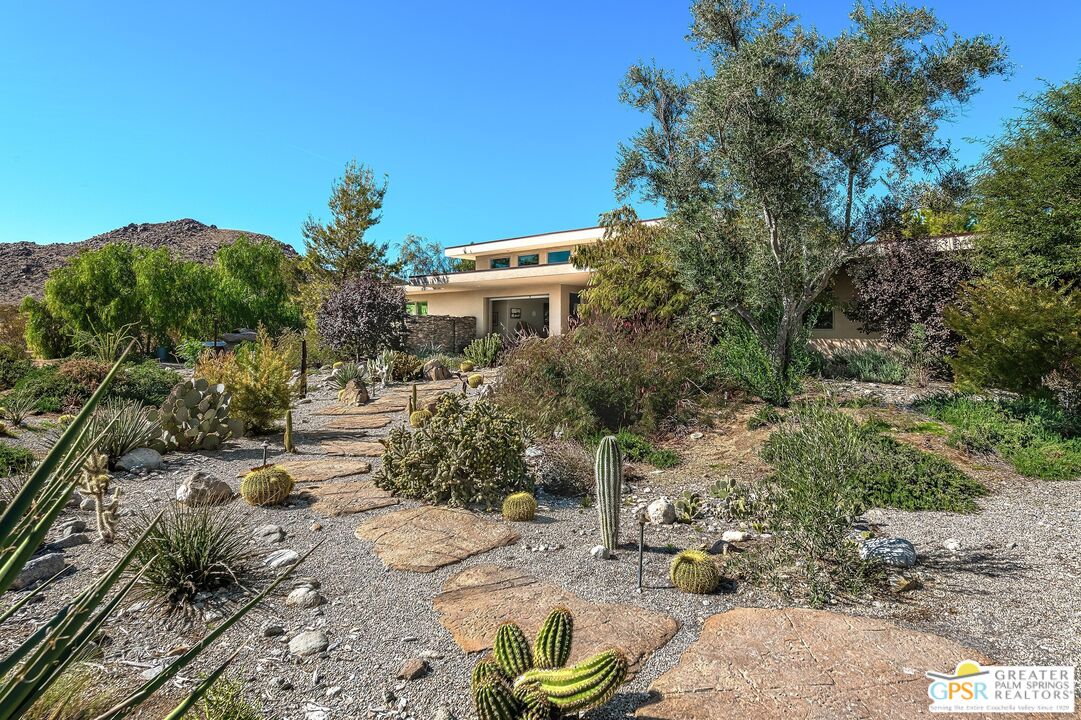 4974 Avenida Del Sol Joshua Tree, CA 92252 - Photo 6 of 36 a view of a garden with a house