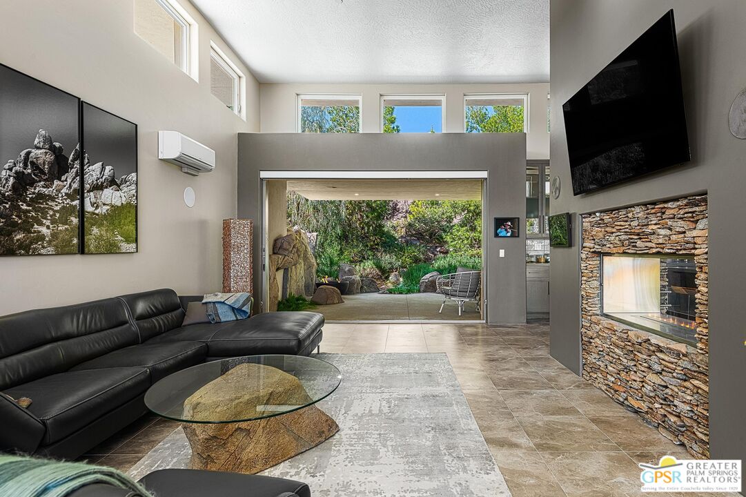 4974 Avenida Del Sol Joshua Tree, CA 92252 - Photo 10 of 36 a living room with fireplace furniture and a flat screen tv
