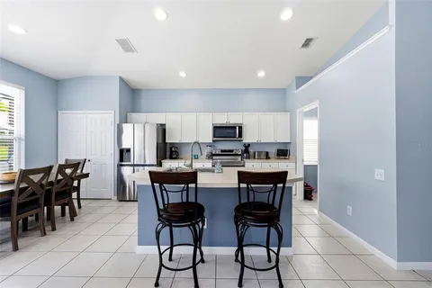 a kitchen with stainless steel appliances a stove sink microwave and cabinets