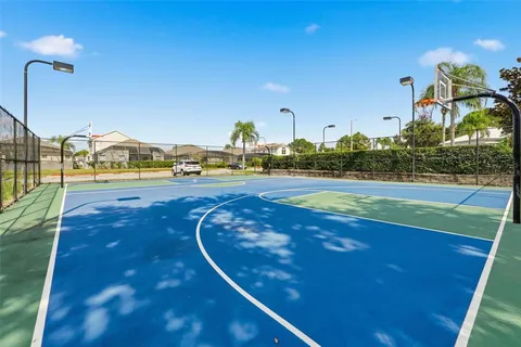 a living room with furniture a flat screen tv and a floor to ceiling window
