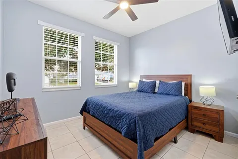 a bathroom with a granite countertop toilet sink and mirror