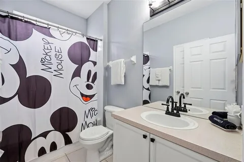 a bedroom with two beds and a chandelier