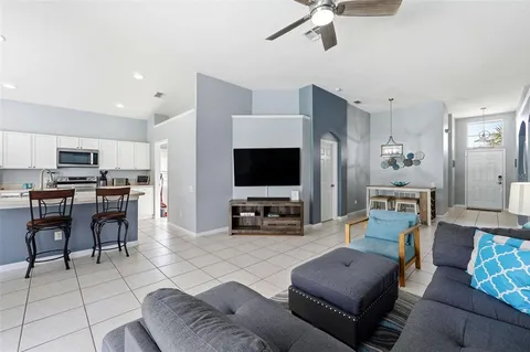 a living room with furniture and a chandelier
