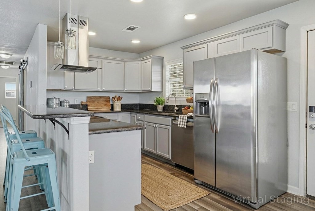 131 Janecek Road Rockport, TX 78382 - Photo 14 of 38 a kitchen with stainless steel appliances granite countertop a refrigerator a sink and white cabinets