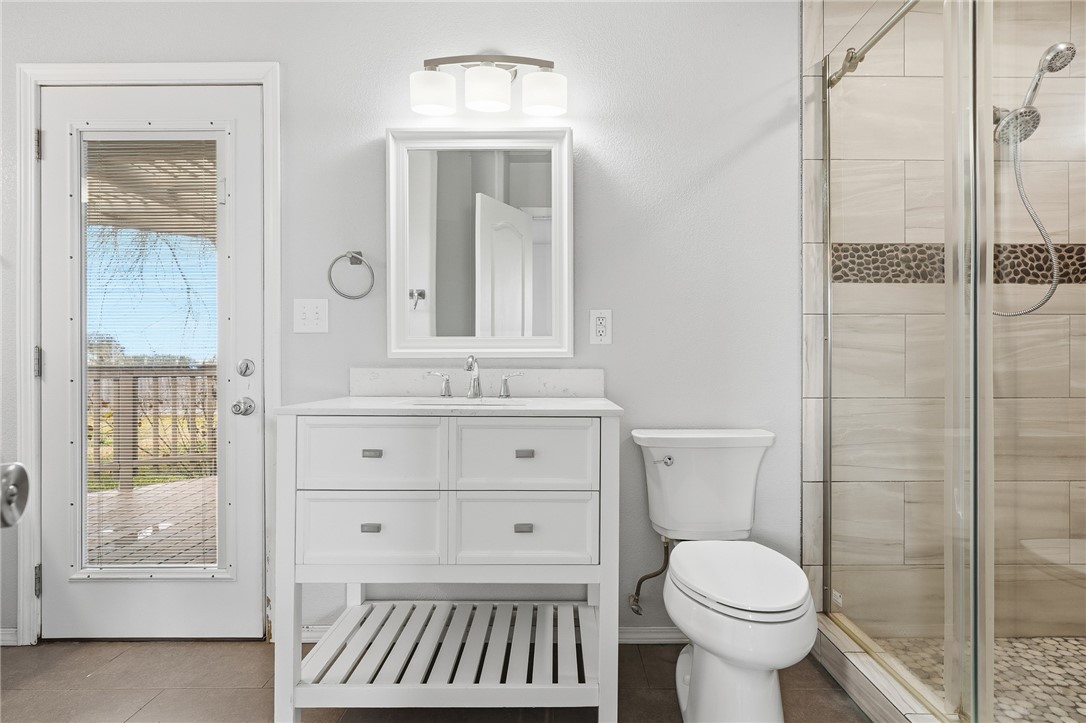 131 Janecek Road Rockport, TX 78382 - Photo 21 of 38 a bathroom with a sink toilet a mirror and shower