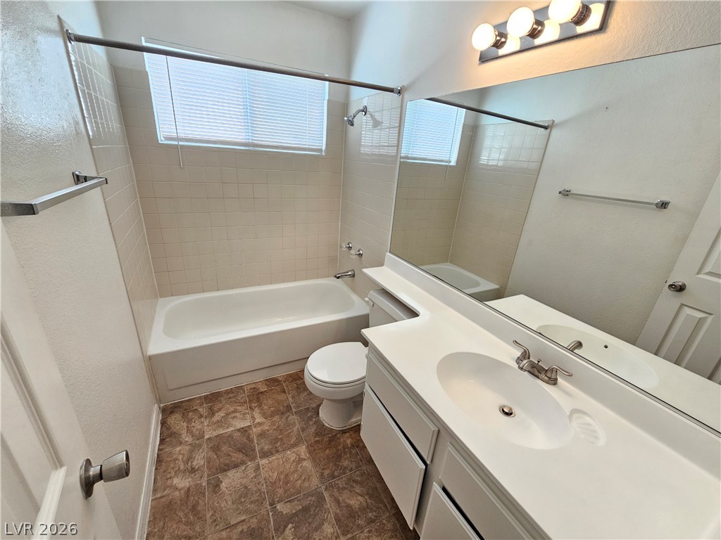 2817 Albemarle Way Henderson, NV 89014 - Photo 16 of 25 Tiled flooring and a practical shower-over-tub design define this functional bathroom.