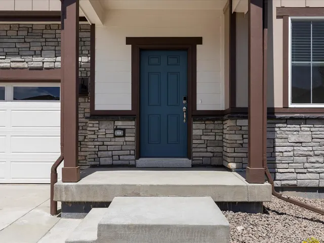 a view of a brick house with a garage