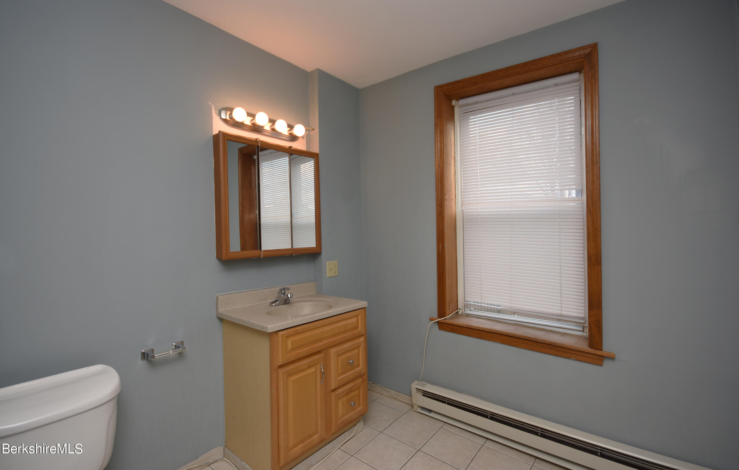 40-48 Reed Street Pittsfield, MA 01201 - Photo 22 of 35 a bathroom with a toilet sink and mirror