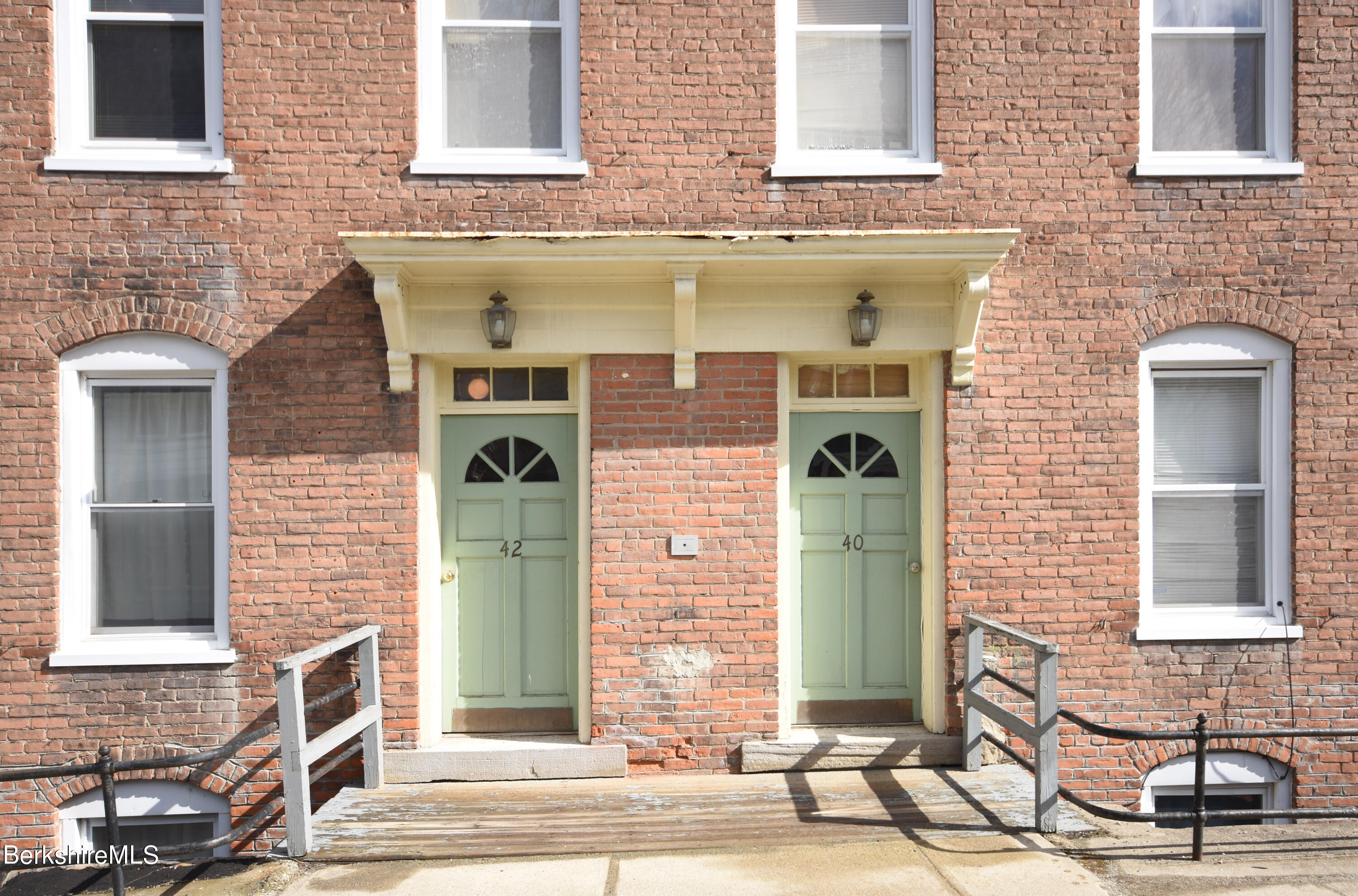 40-48 Reed Street Pittsfield, MA 01201 - Photo 3 of 35 a view of a brick house with large windows