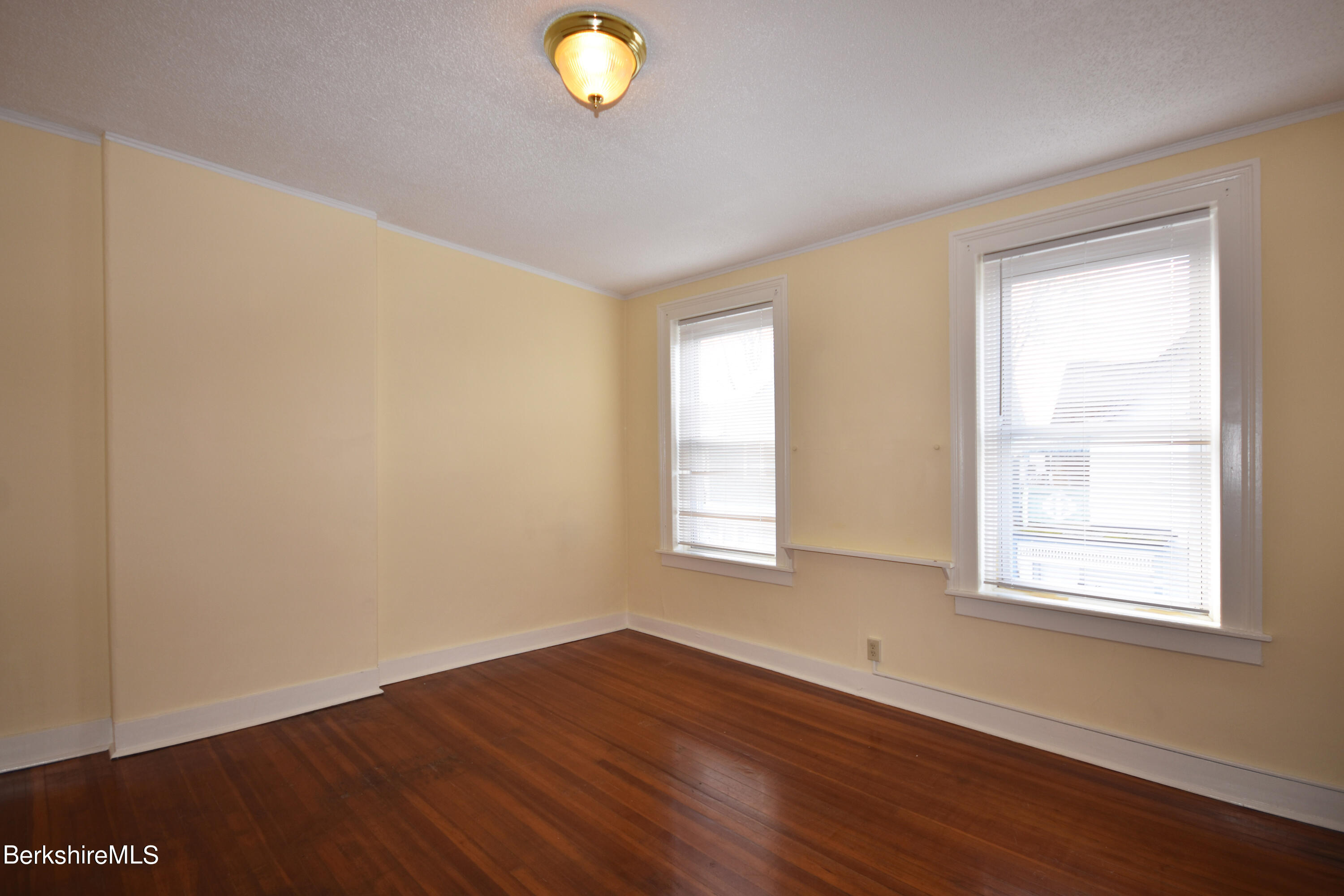 40-48 Reed Street Pittsfield, MA 01201 - Photo 5 of 35 an empty room with wooden floor and windows