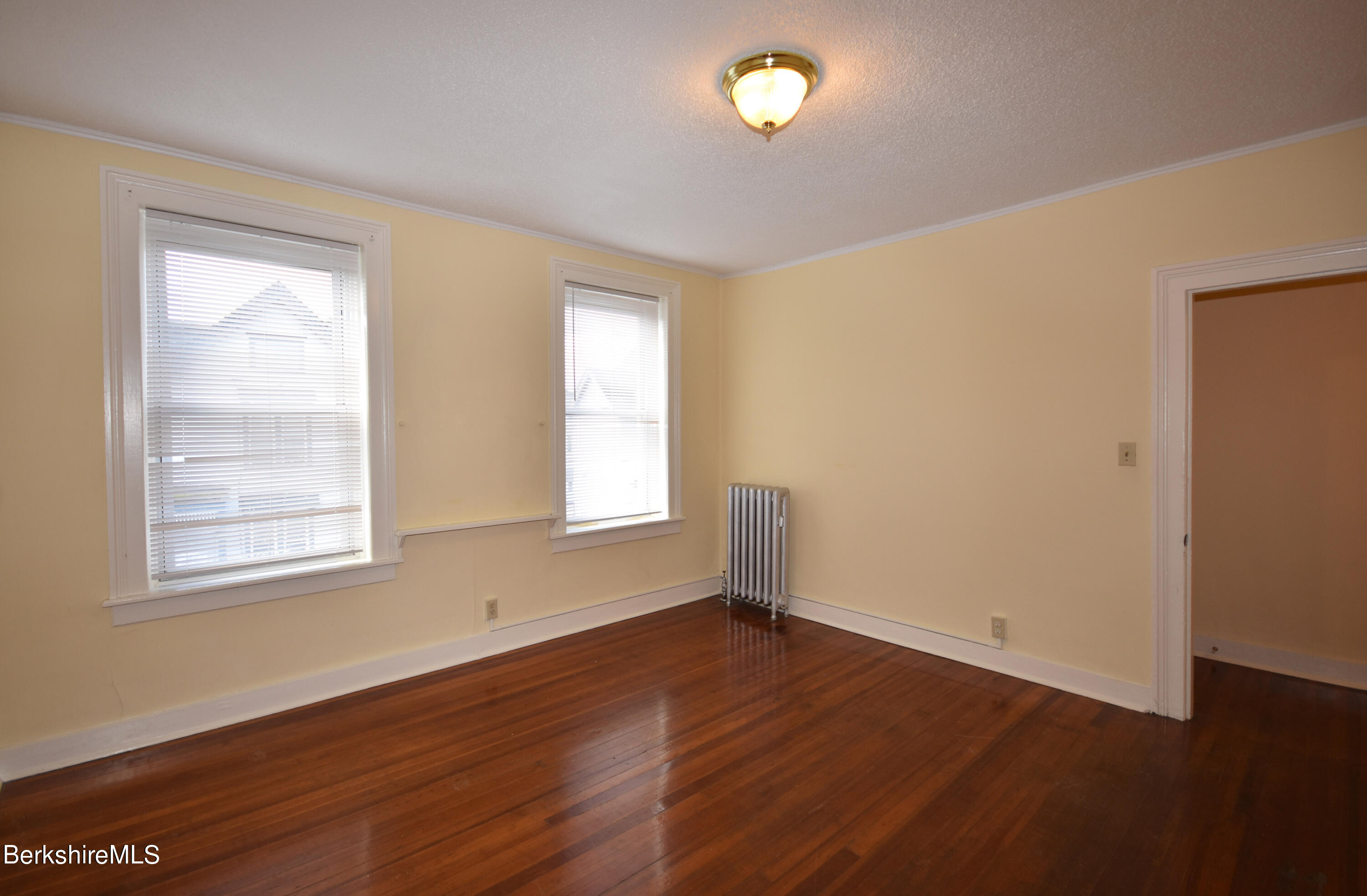 40-48 Reed Street Pittsfield, MA 01201 - Photo 6 of 35 an empty room with wooden floor and windows