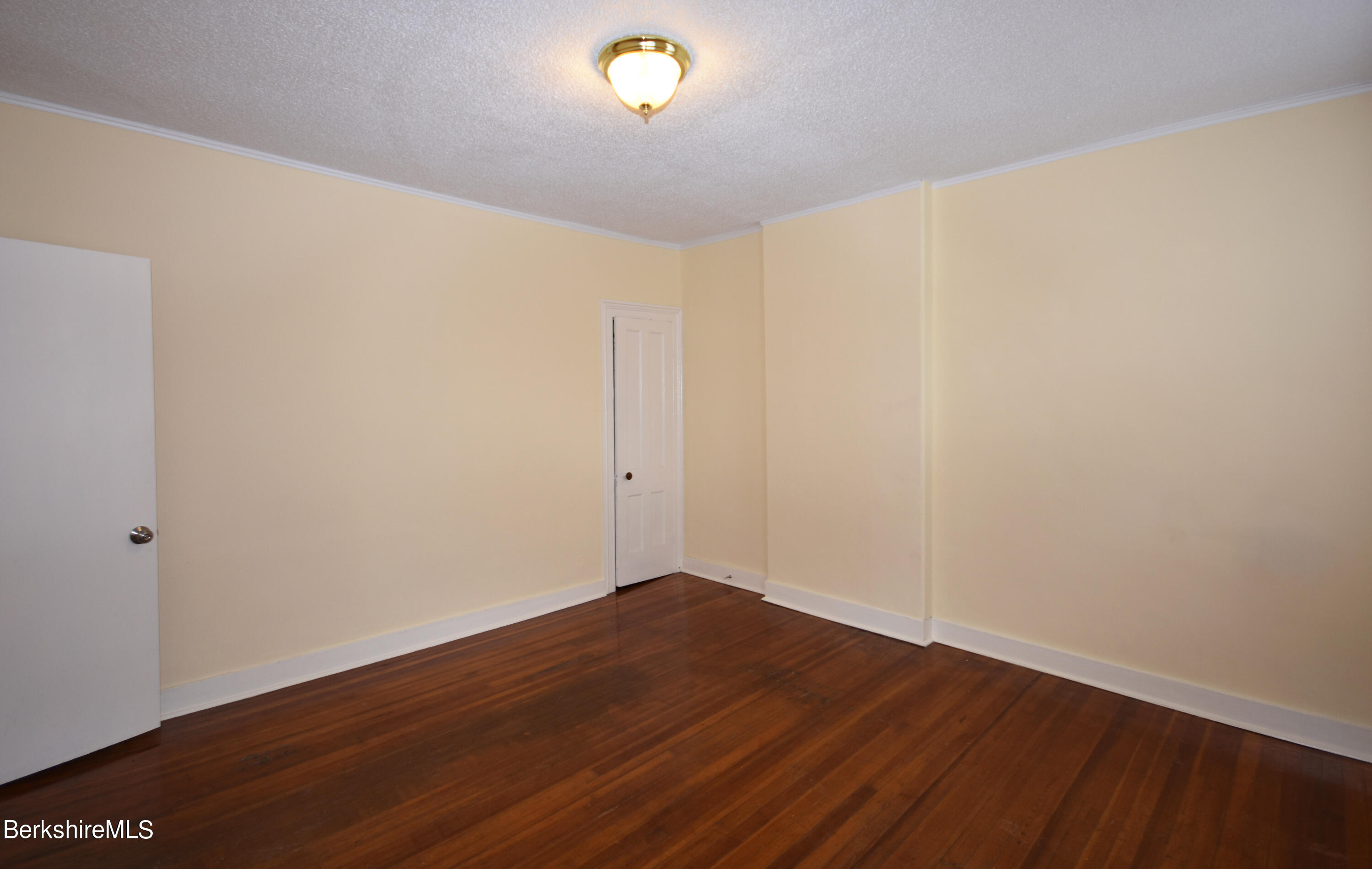40-48 Reed Street Pittsfield, MA 01201 - Photo 7 of 35 a view of an empty room with wooden floor and a window