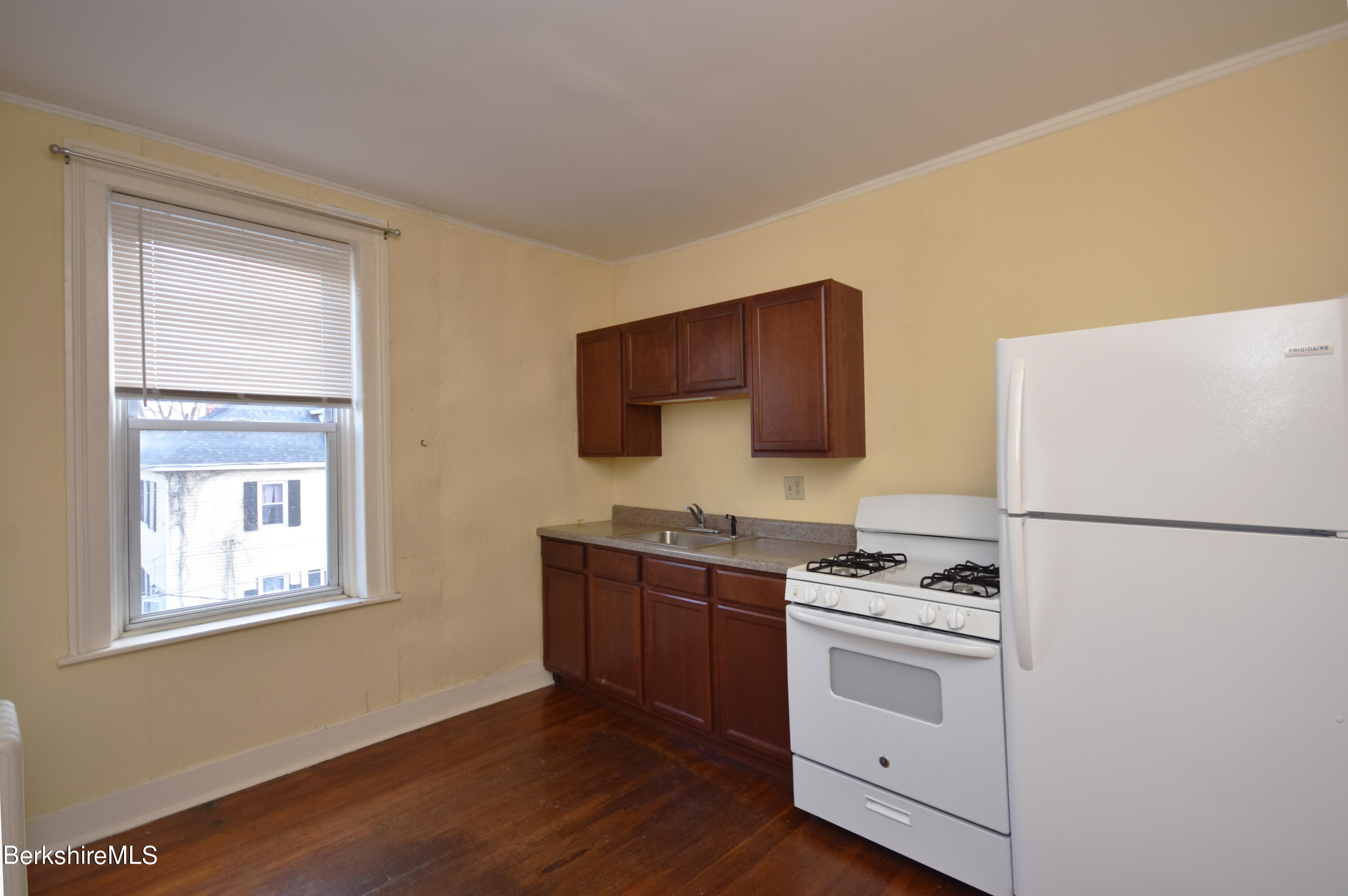 40-48 Reed Street Pittsfield, MA 01201 - Photo 8 of 35 a kitchen with stainless steel appliances a refrigerator stove and sink