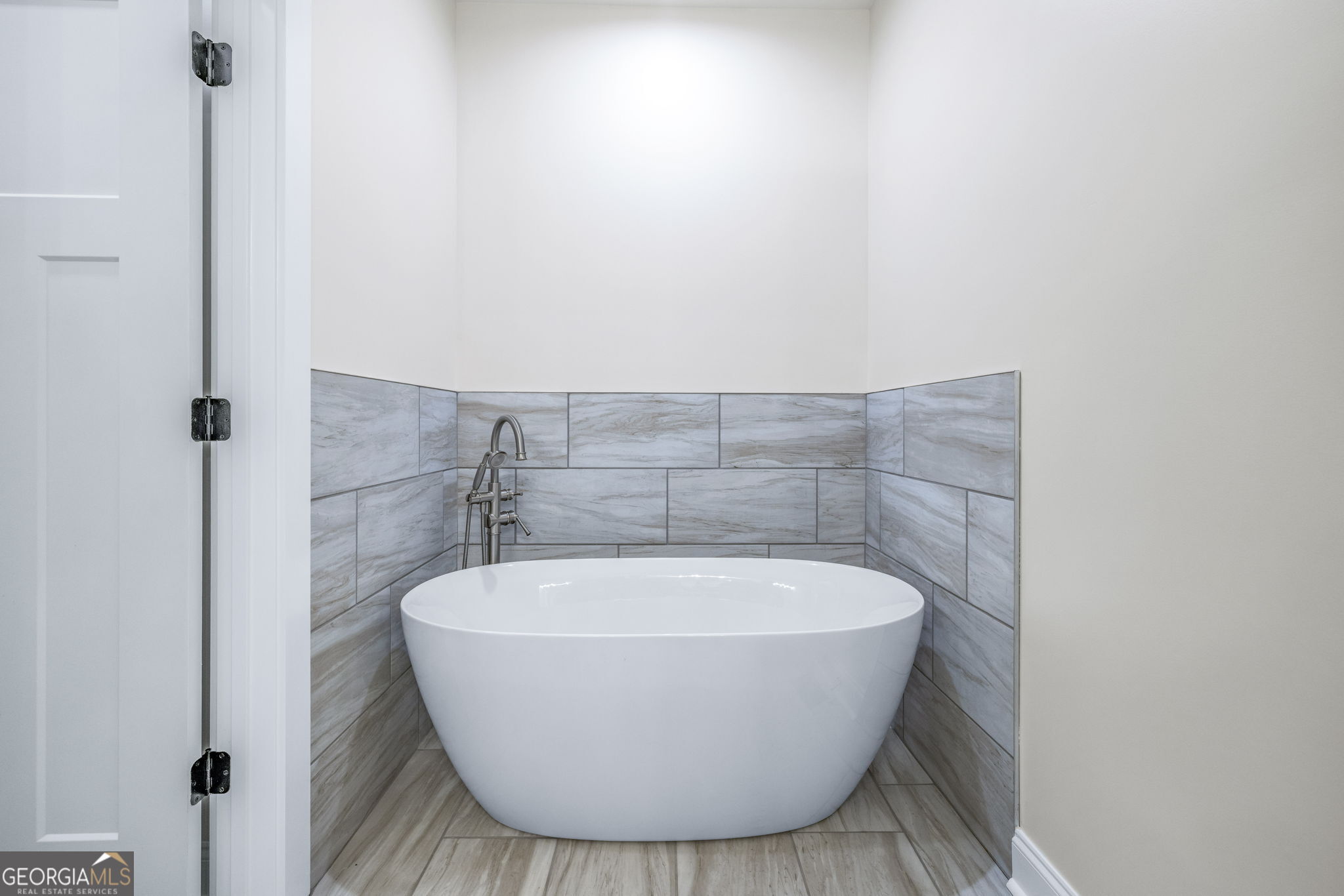 178 Hazel Creek Road Mount Airy, GA 30563 - Photo 16 of 34 a white bath tub sitting in a bathroom