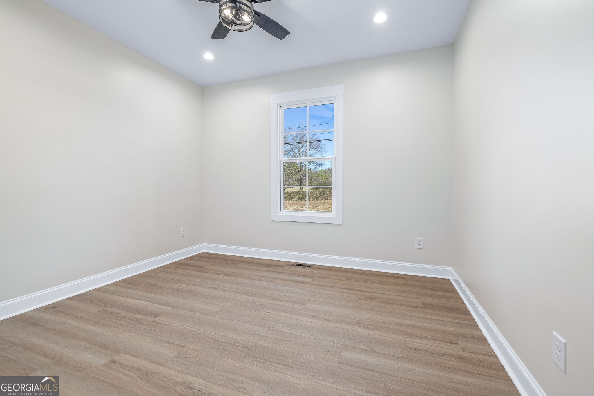 178 Hazel Creek Road Mount Airy, GA 30563 - Photo 19 of 34 wooden floor in an empty room with a window