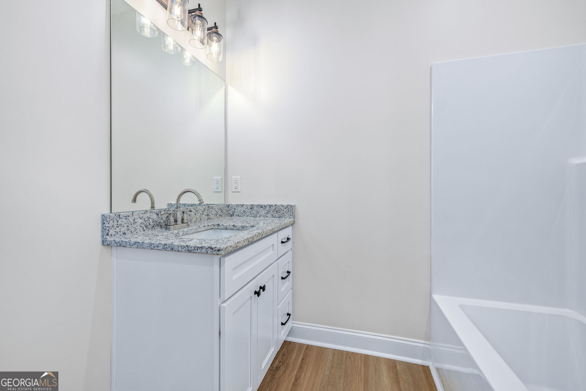 178 Hazel Creek Road Mount Airy, GA 30563 - Photo 23 of 34 a bathroom with a granite countertop sink and a mirror