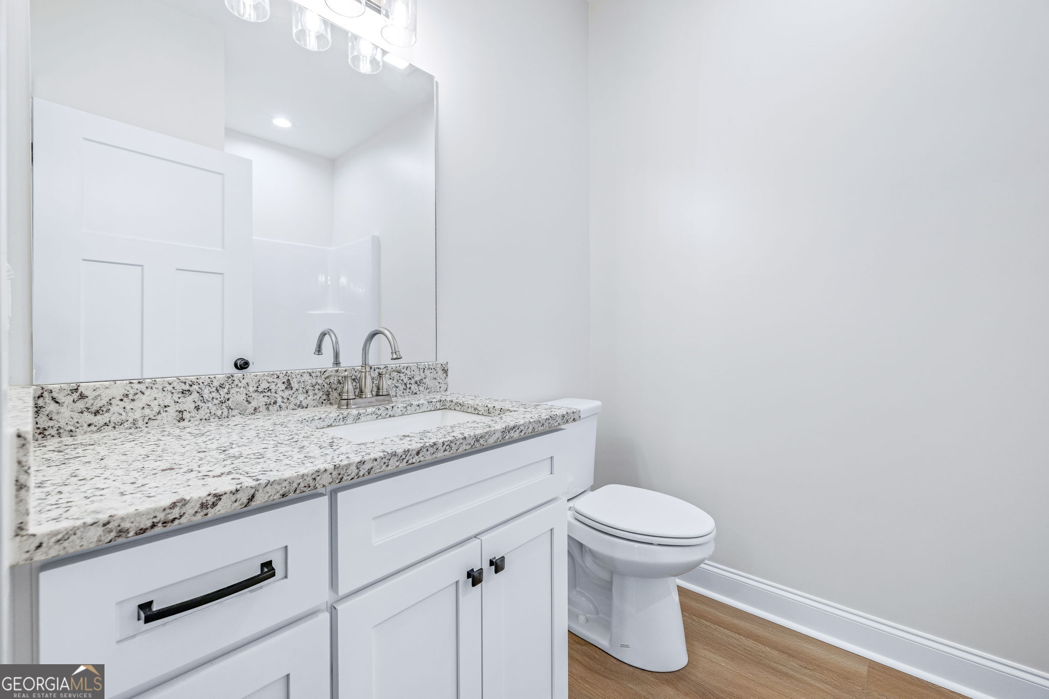 178 Hazel Creek Road Mount Airy, GA 30563 - Photo 25 of 34 a bathroom with a granite countertop sink a toilet and a mirror