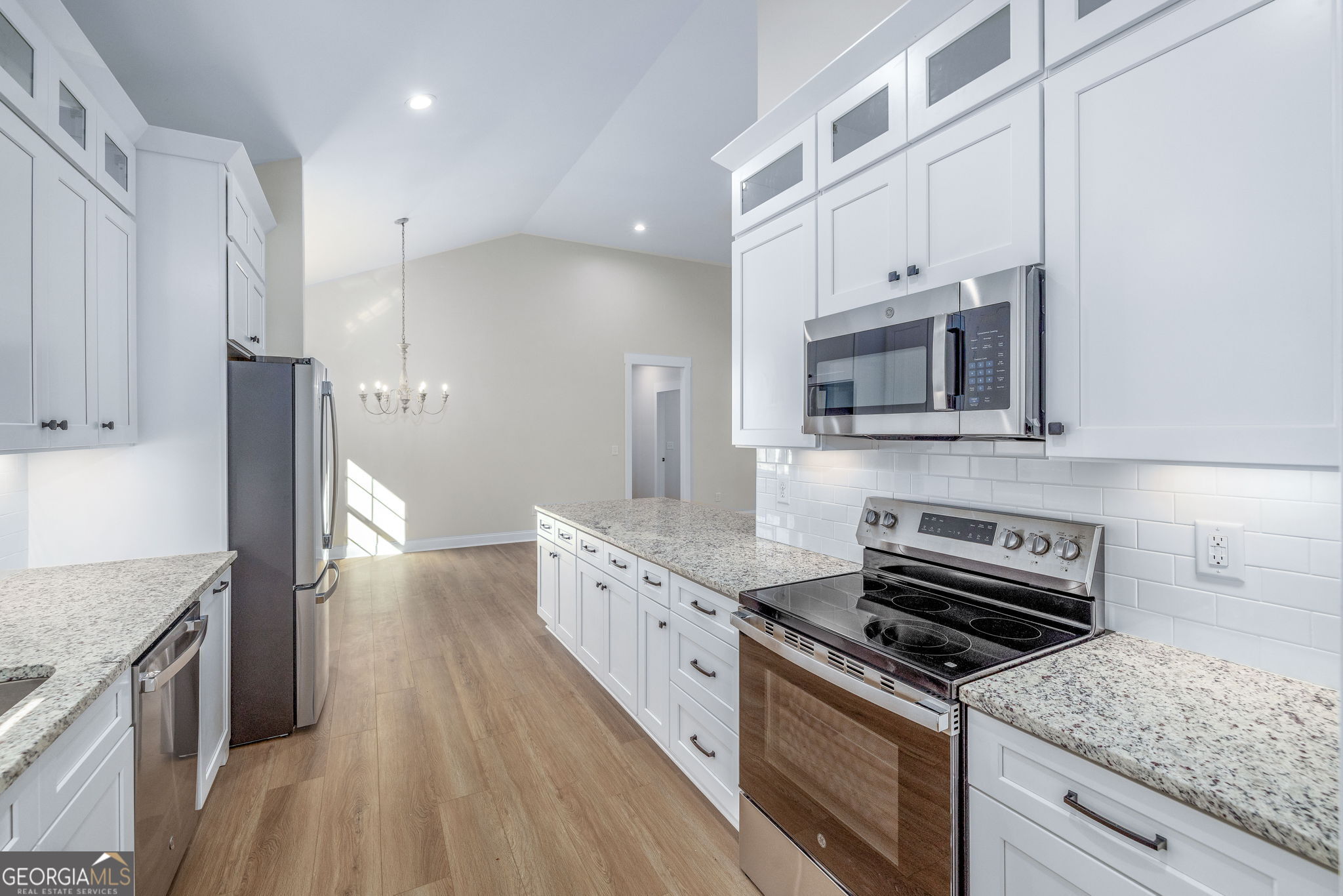 178 Hazel Creek Road Mount Airy, GA 30563 - Photo 4 of 34 a kitchen with stainless steel appliances granite countertop a stove a sink and a refrigerator