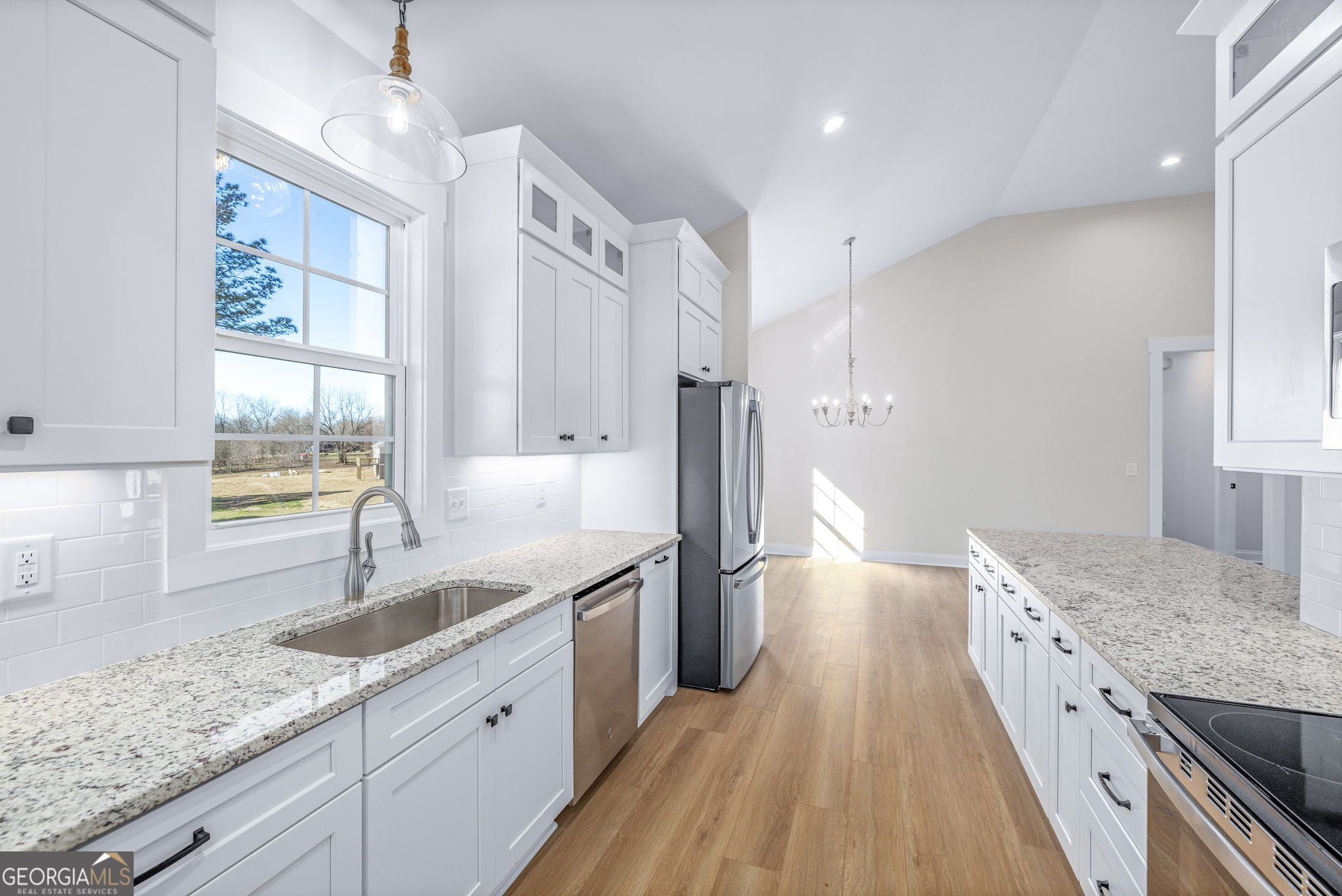 178 Hazel Creek Road Mount Airy, GA 30563 - Photo 5 of 34 a large kitchen with granite countertop a lot of counter space and wooden floor