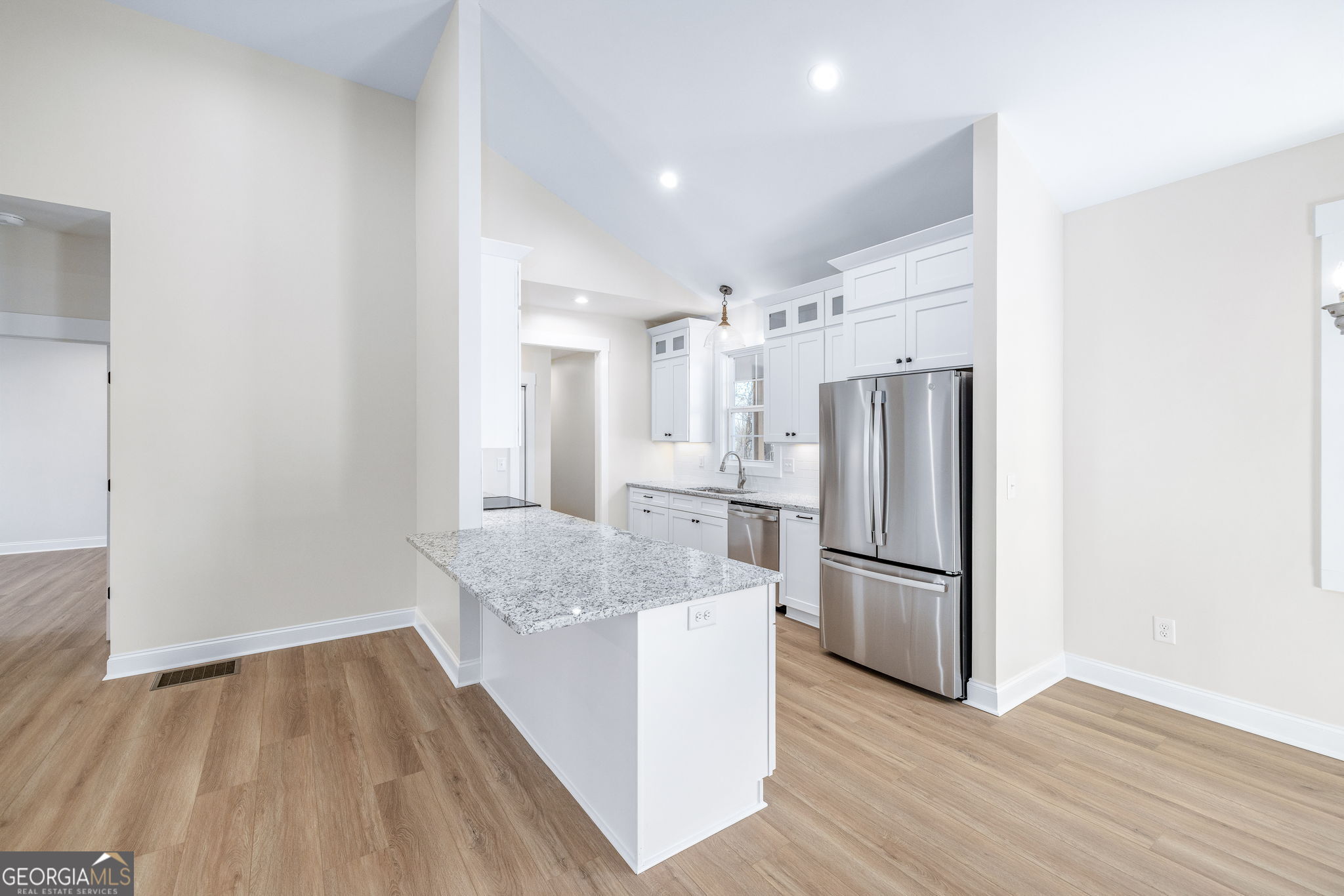178 Hazel Creek Road Mount Airy, GA 30563 - Photo 6 of 34 a kitchen with refrigerator and wooden floor