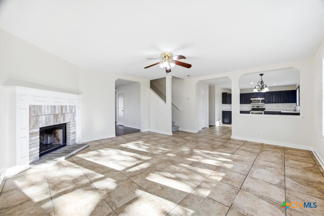 2030 Castleberry Ridge New Braunfels, TX 78130 - Photo 14 of 43 a view of livingroom with kitchen island furniture and a fireplace