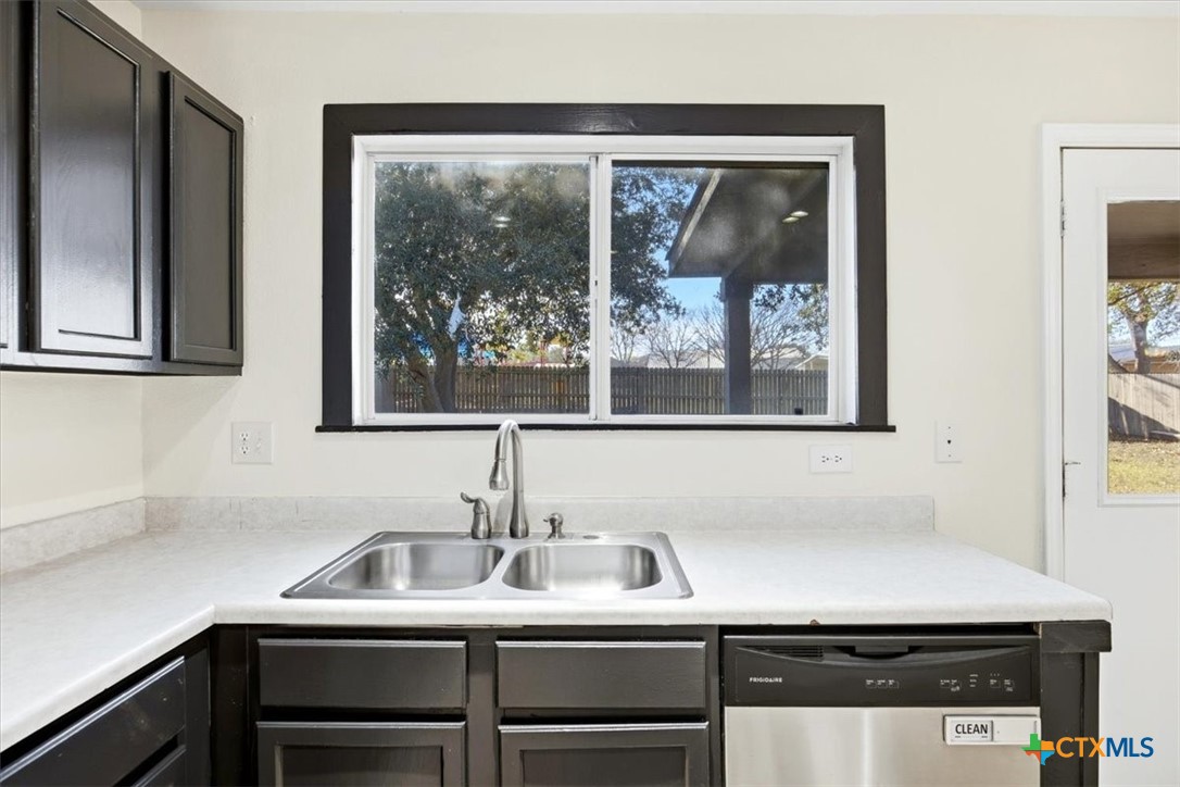 2030 Castleberry Ridge New Braunfels, TX 78130 - Photo 20 of 43 a view of a sink and a refrigerator in a kitchen