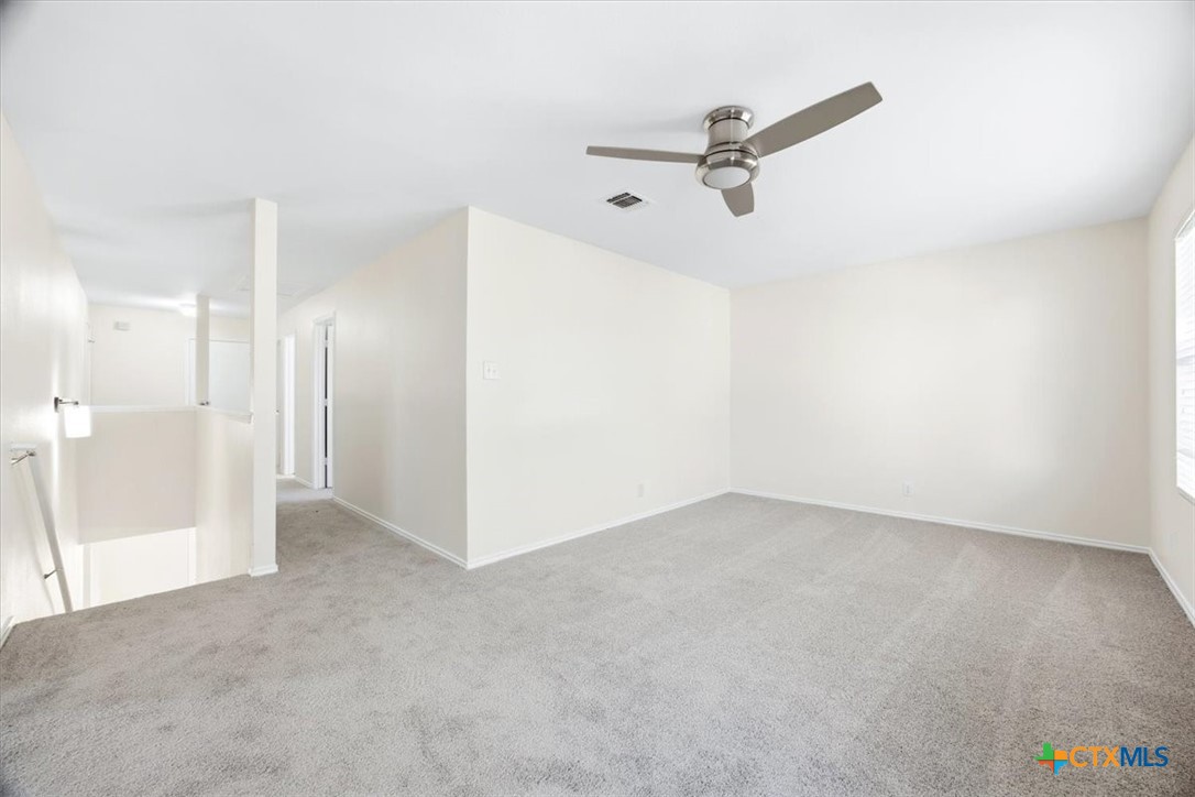 2030 Castleberry Ridge New Braunfels, TX 78130 - Photo 24 of 43 a view of a livingroom with a ceiling fan and refrigerator