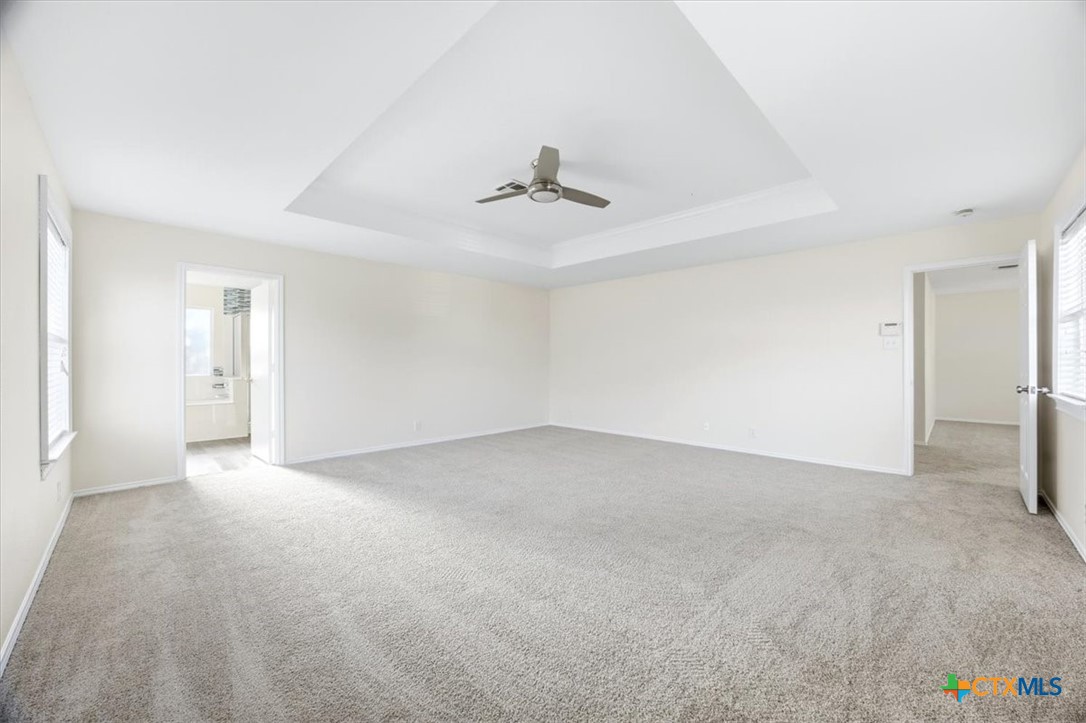 2030 Castleberry Ridge New Braunfels, TX 78130 - Photo 26 of 43 an empty room with a ceiling fan and carpet