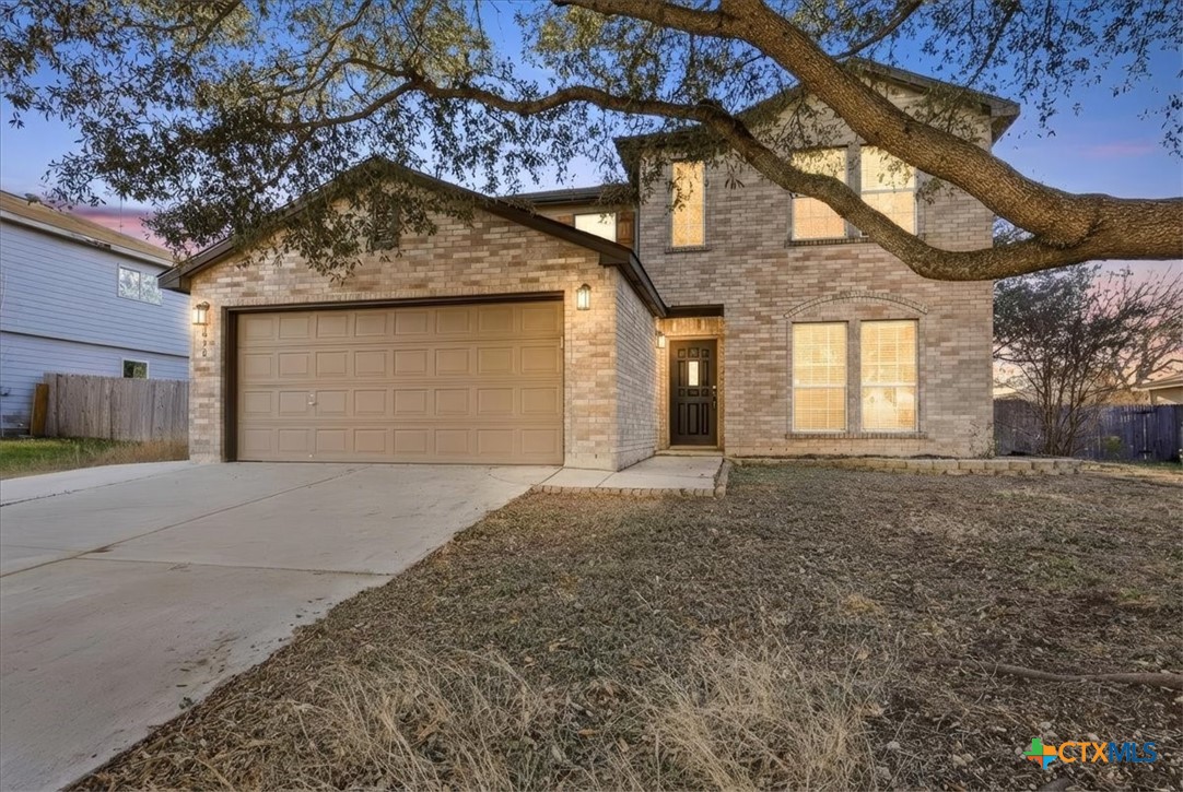 2030 Castleberry Ridge New Braunfels, TX 78130 - Photo 5 of 43 a front view of a house with a yard and garage