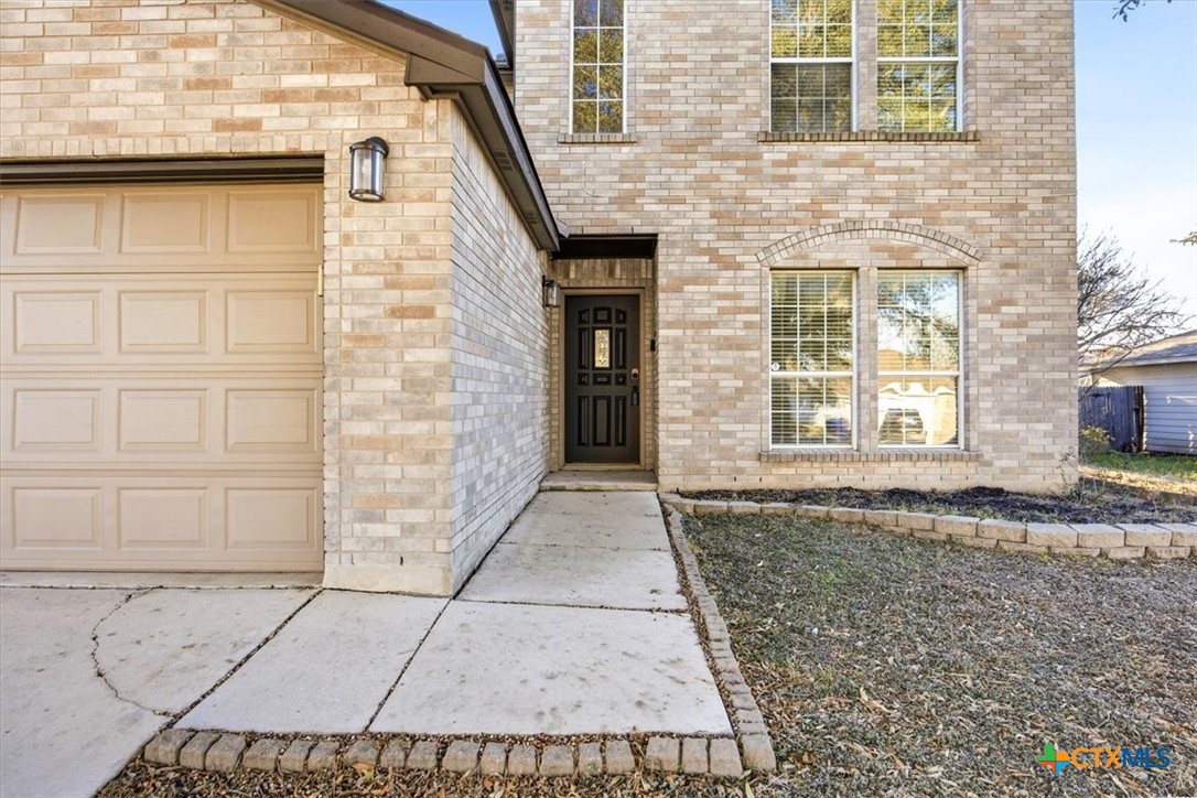 2030 Castleberry Ridge New Braunfels, TX 78130 - Photo 7 of 43 a view of a brick house with a door and a window