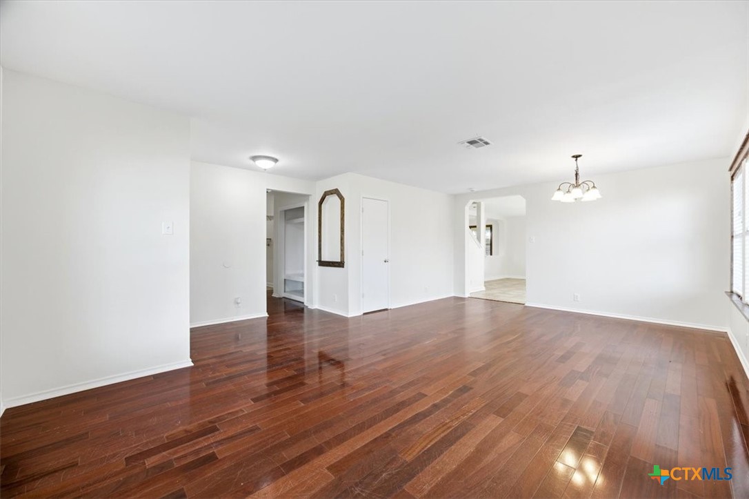2030 Castleberry Ridge New Braunfels, TX 78130 - Photo 9 of 43 a view of empty room with wooden floor